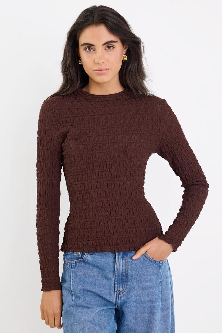 Image of a model wearing Tops. Product name - Captive Chocolate Lace Knit Long Sleeved Top in Chocolate Lace Knit colour by brand - Among the Brave