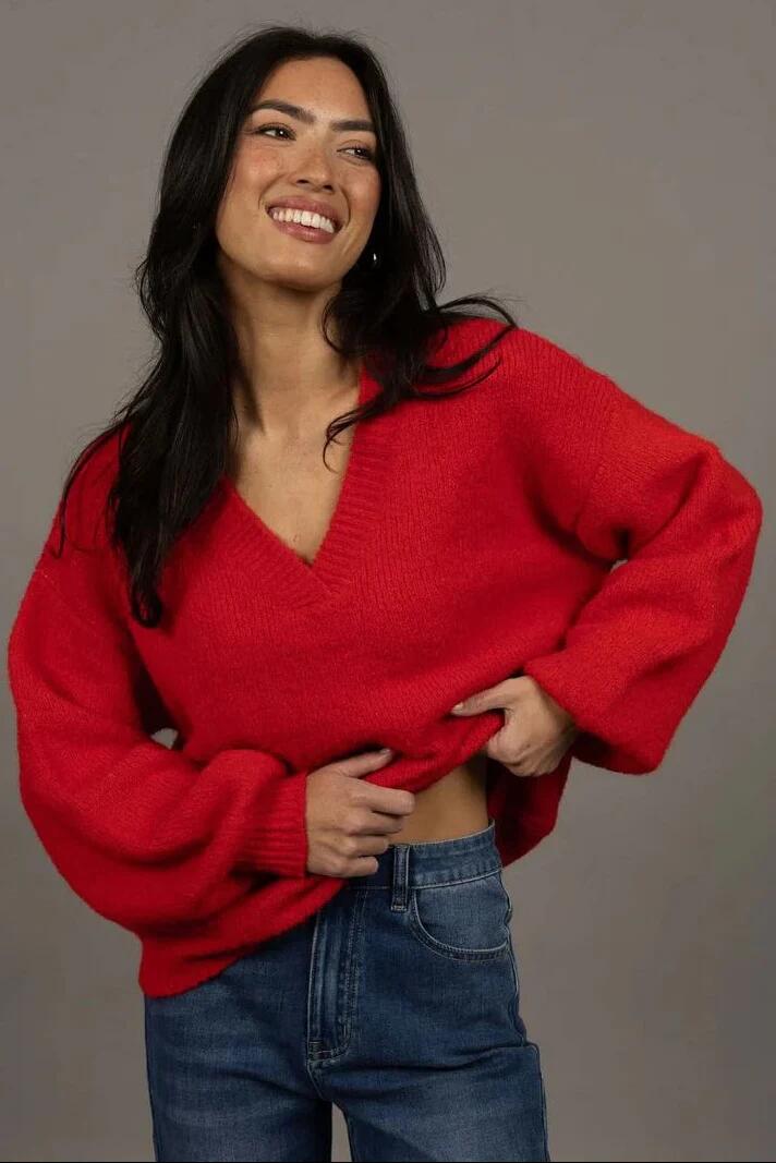 Image of a model wearing Outerwear. Product name - Nouveau Scarlet V Neck Wool Blend Jumper in Red colour by brand - Humidity Lifestyle