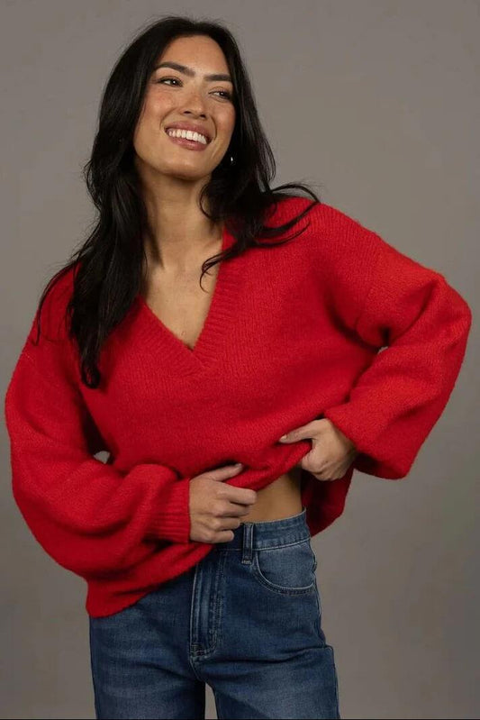 Image of a model wearing Outerwear. Product name - Nouveau Scarlet V Neck Wool Blend Jumper in Red colour by brand - Humidity Lifestyle