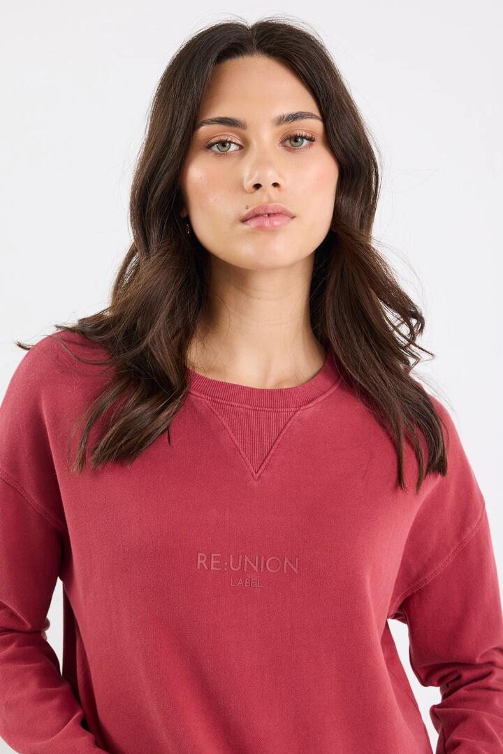 Image of a model wearing Outerwear. Product name - Scribe Red Paprika Cotton Re:Union Sweatshirt in Red Paprika colour by brand - RE:UNION Label