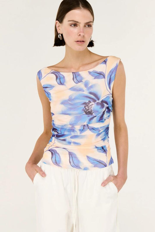 Image of a model wearing Tops. Product name - Fleur Blue Blurred Floral Sleeveless Mesh Top in Blue colour by brand - Staple The Label
