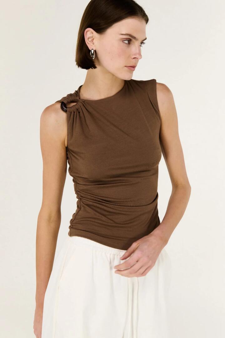 Image of a model wearing Tops. Product name - Blair Chocolate Hardware Feature Sleeveless Top in Chocolate colour by brand - Staple The Label
