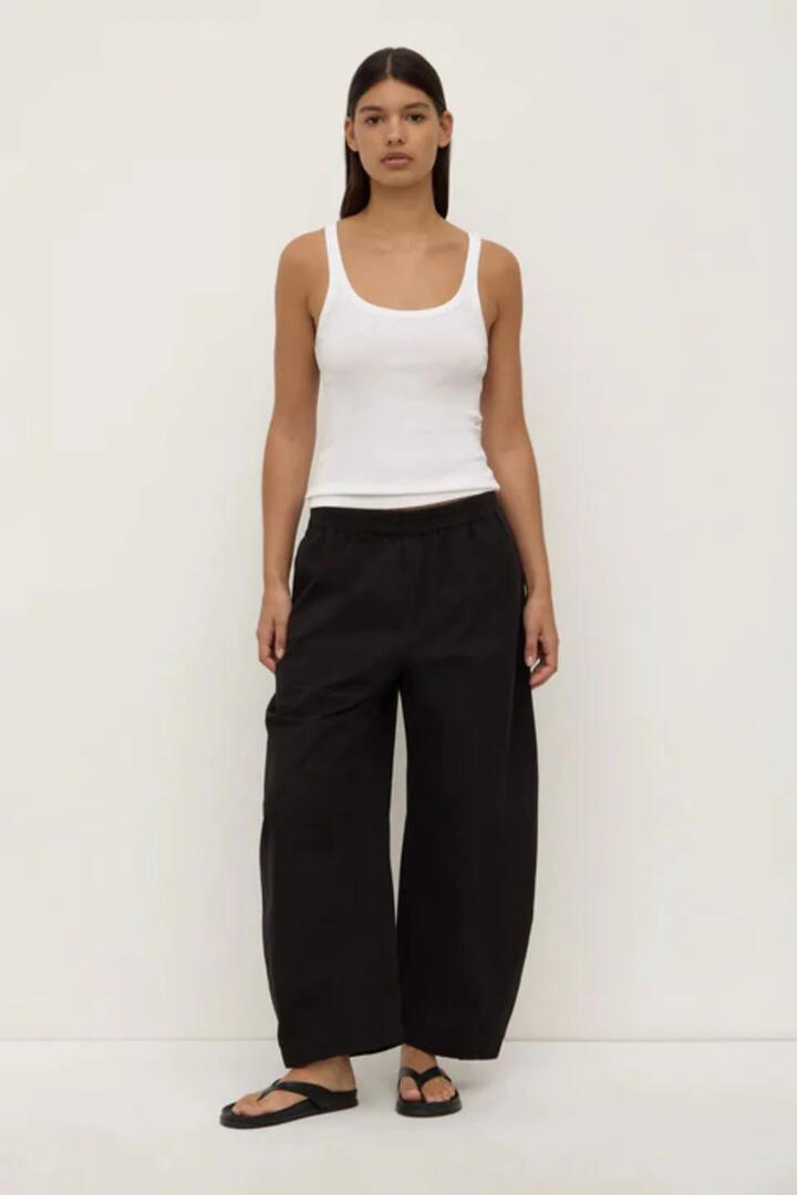 Image of a model wearing Pants. Product name - Lola Black Oversized Barrel Pant in Black colour by brand - Assembly Label