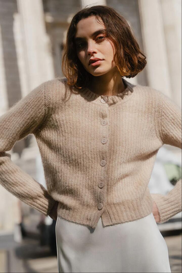 Image of a model wearing Outerwear. Product name - Highlight Biscuit Mohair Blend Crewneck Cardigan in Biscuit colour by brand - Ivy + Jack