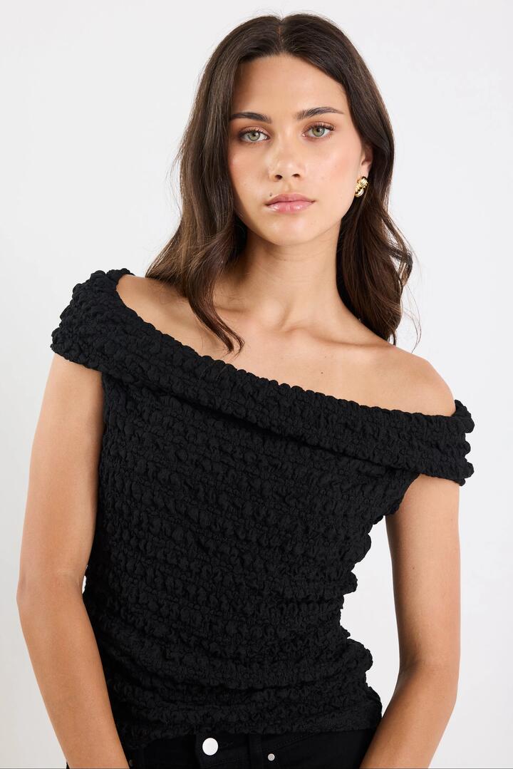 Image of a model wearing Tops. Product name - Nightlife Black Lace Stretch Multi Fit Sleeveless Top in Black Lace colour by brand - Stories be Told