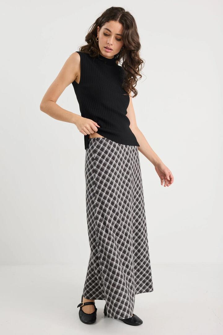 Image of a model wearing Skirts. Product name - Soulmate Black White Check Bias Cut Midi Skirt in Black White Check colour by brand - Among the Brave