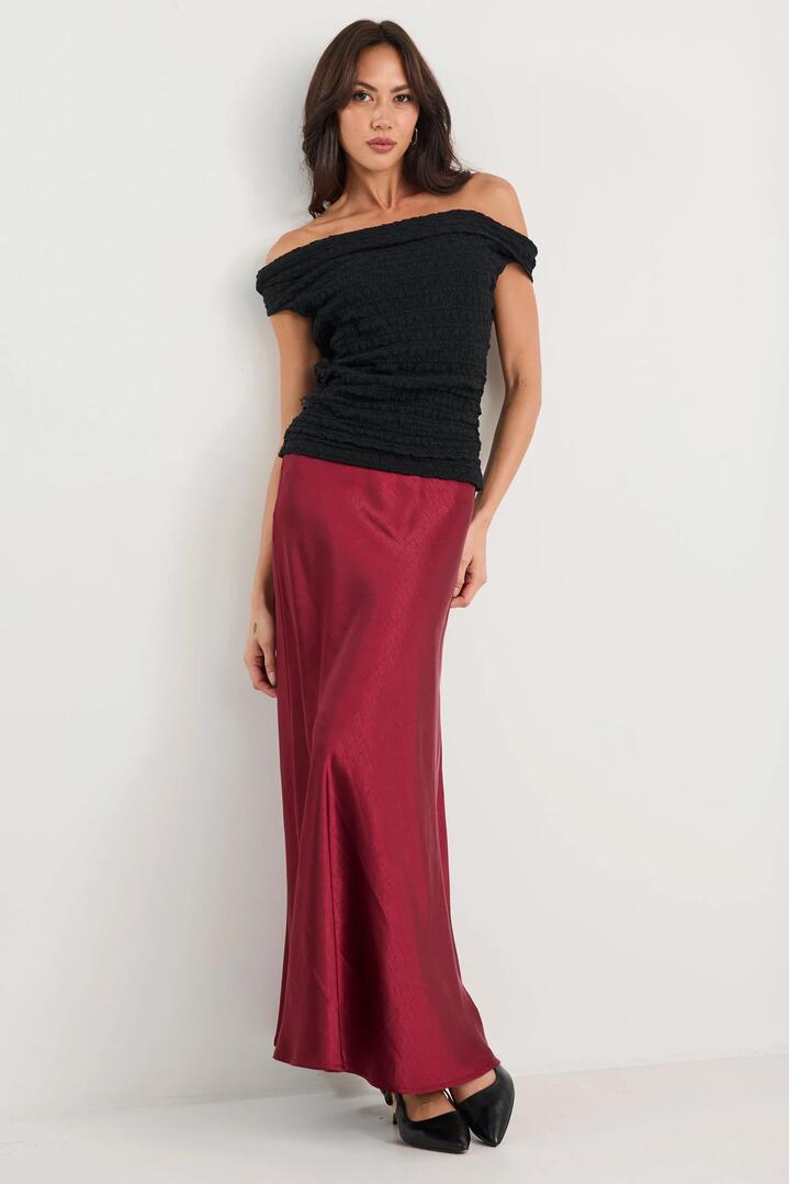 Image of a model wearing Skirts. Product name - Preserve Burgundy Satin Floaty Bias Midi Skirt in Burgundy Satin colour by brand - By Rosa.