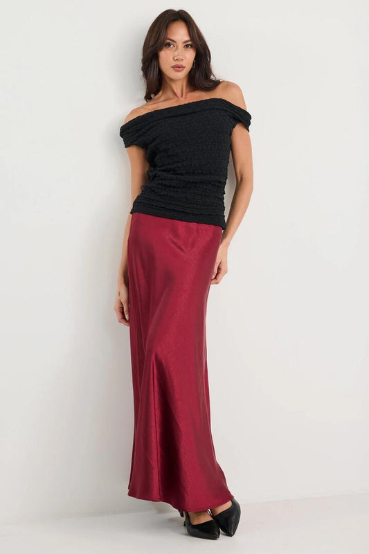 Image of a model wearing Skirts. Product name - Preserve Burgundy Satin Floaty Bias Midi Skirt in Burgundy Satin colour by brand - By Rosa.