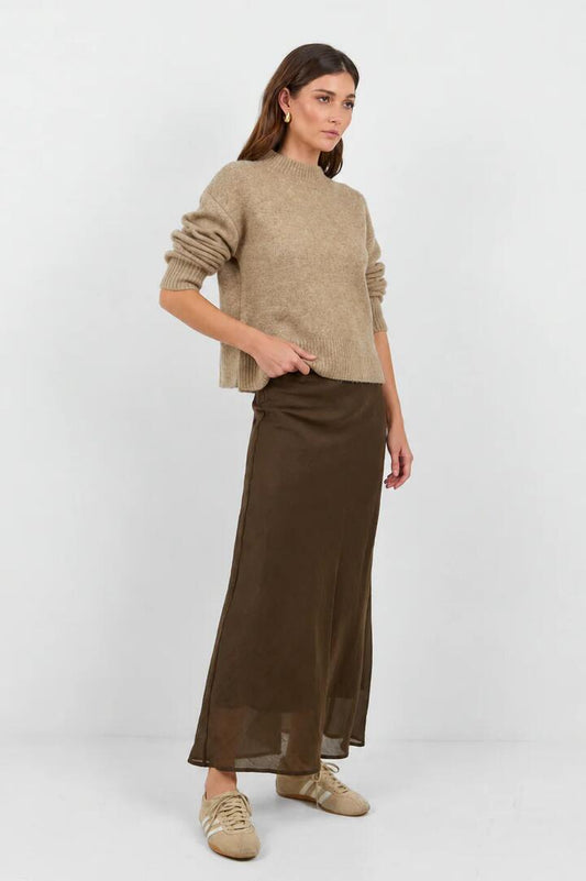Image of a model wearing Skirts. Product name - Sahara Chocolate Luxe Linen Blend Bias Maxi Skirt in Chocolate colour by brand - Stories be Told