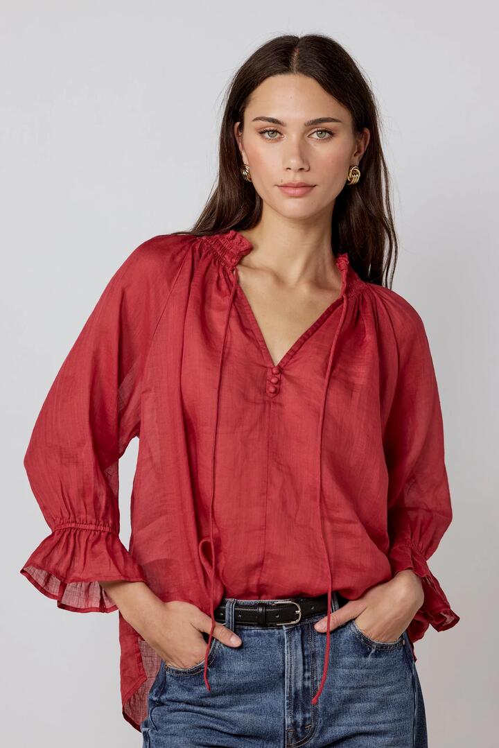 Image of a model wearing Tops. Product name - Odyssey Red Shirred Neck Button Mid Sleeve Top in Red colour by brand - Among the Brave