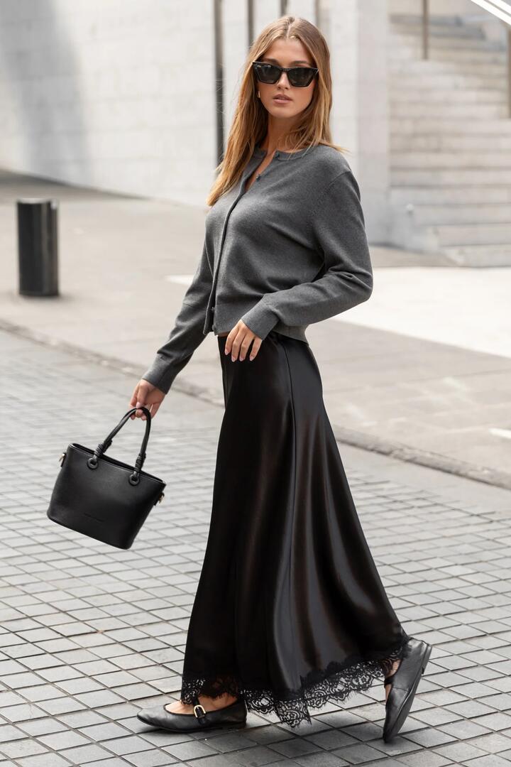 Image of a model wearing Skirts. Product name - Margarita Black Satin Lace Trim Bias Maxi Skirt in Black colour by brand - Georgia Zoe