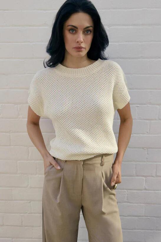 Image of a model wearing Outerwear. Product name - Lobby Parchment Linen Blend SS Knit Top in Natural colour by brand - Esmaee