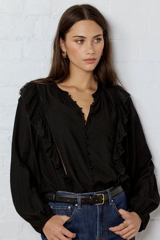Image of a model wearing Tops. Product name - Integrity Black Sheer Frill Detail Long Sleeve Top in Black Sheer colour by brand - Ivy + Jack