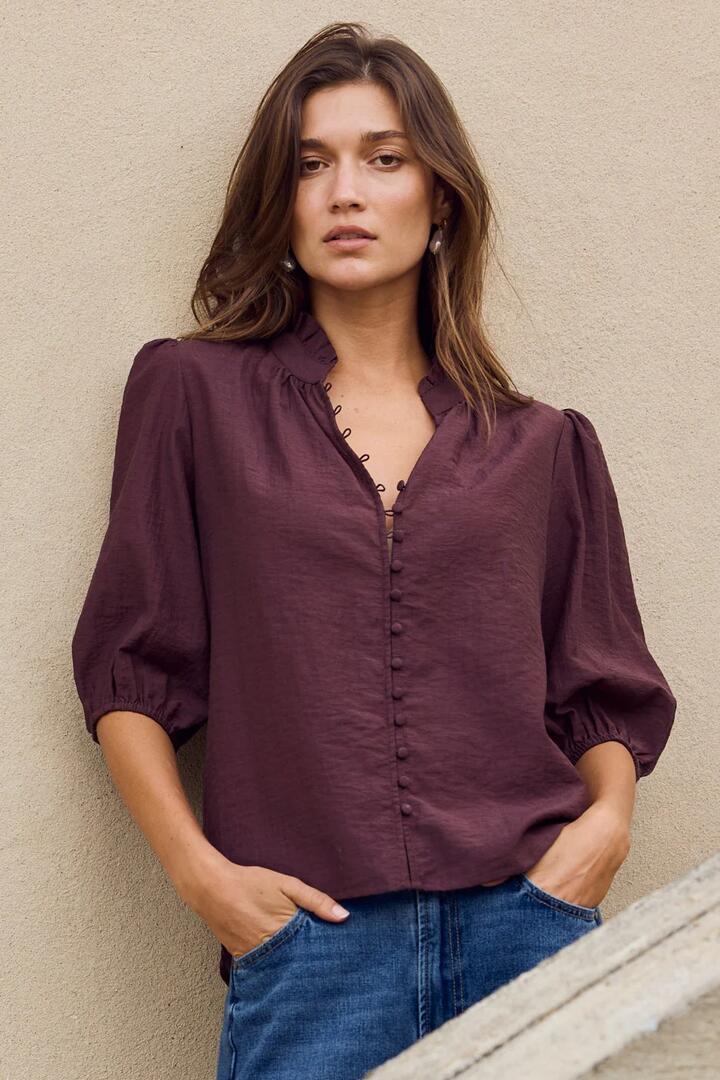Image of a model wearing Tops. Product name - Continuance Chocolate Semi Sheer High Neck Buttoned Short Sleeve Top in Chocolate colour by brand - Ivy + Jack