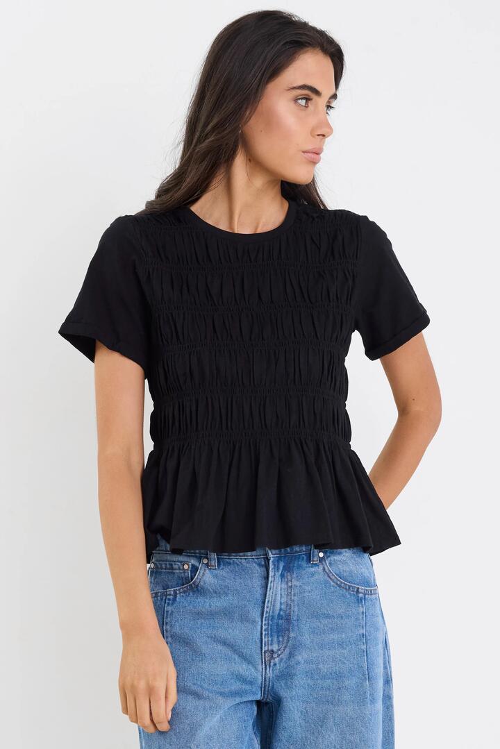 Image of a model wearing Tops. Product name - Neat Black Slub Shirred Detail SS Tee in Black colour by brand - Stories be Told