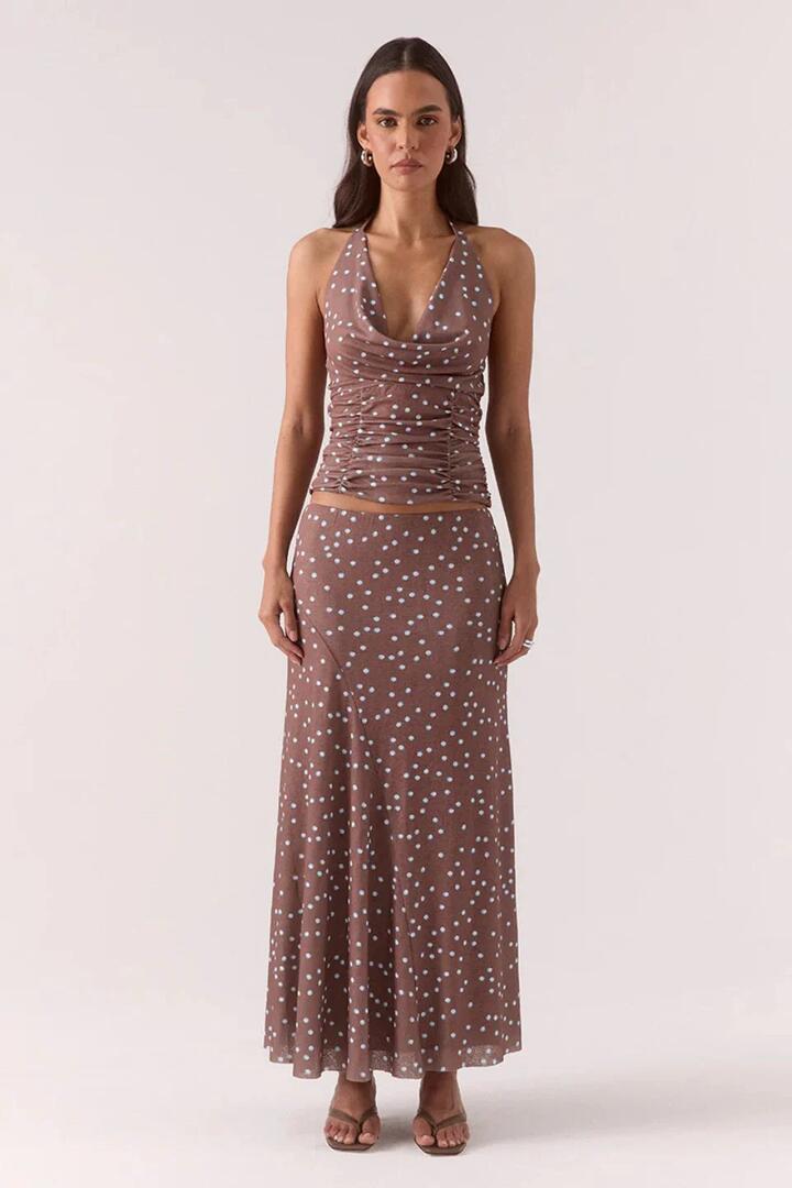 Image of a model wearing Skirts. Product name - Delilah Mocha Polka Dot Maxi Skirt in Brown colour by brand - Sovere