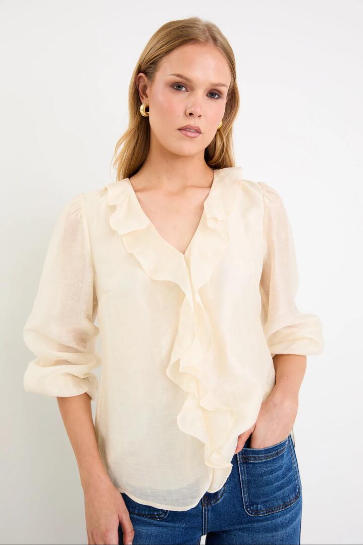 Image of a model wearing Tops. Product name - Breeze Ivory Frill Front LS Top in Ivory colour by brand - By Rosa.