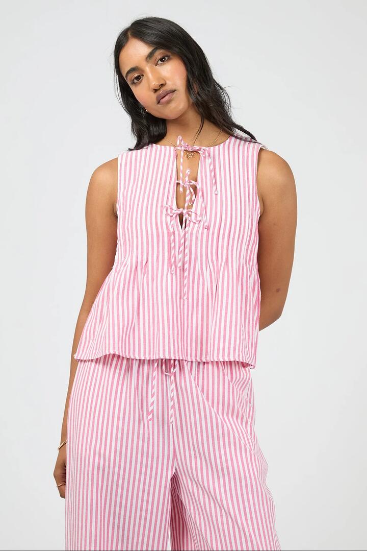 Image of a model wearing Tops. Product name - Franca Pink Stripe Front Tie Sleeveless Top in Pink colour by brand - All About Eve