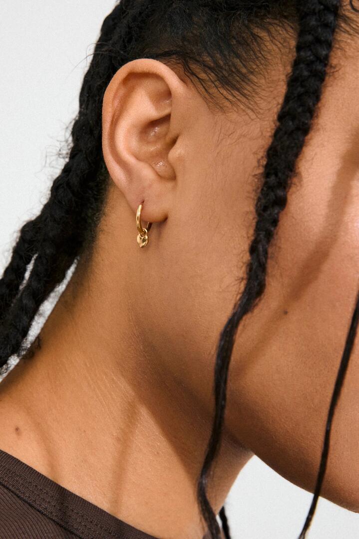 Image of Jewelry. Product name - Alaia Heart Charm Gold Recycled Hoop Earrings in Gold colour by brand - Pilgrim