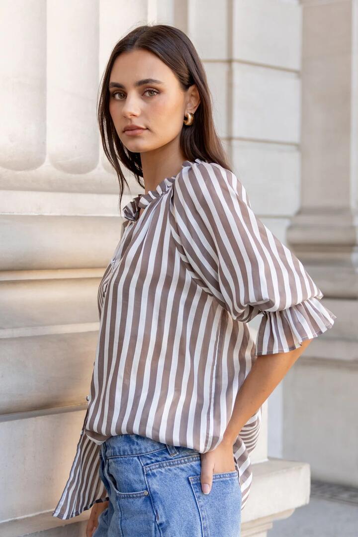 Image of a model wearing Tops. Product name - Noetic Chocolate Stripe Short Sleeve Blouse in Chocolate Stripe colour by brand - Ivy + Jack