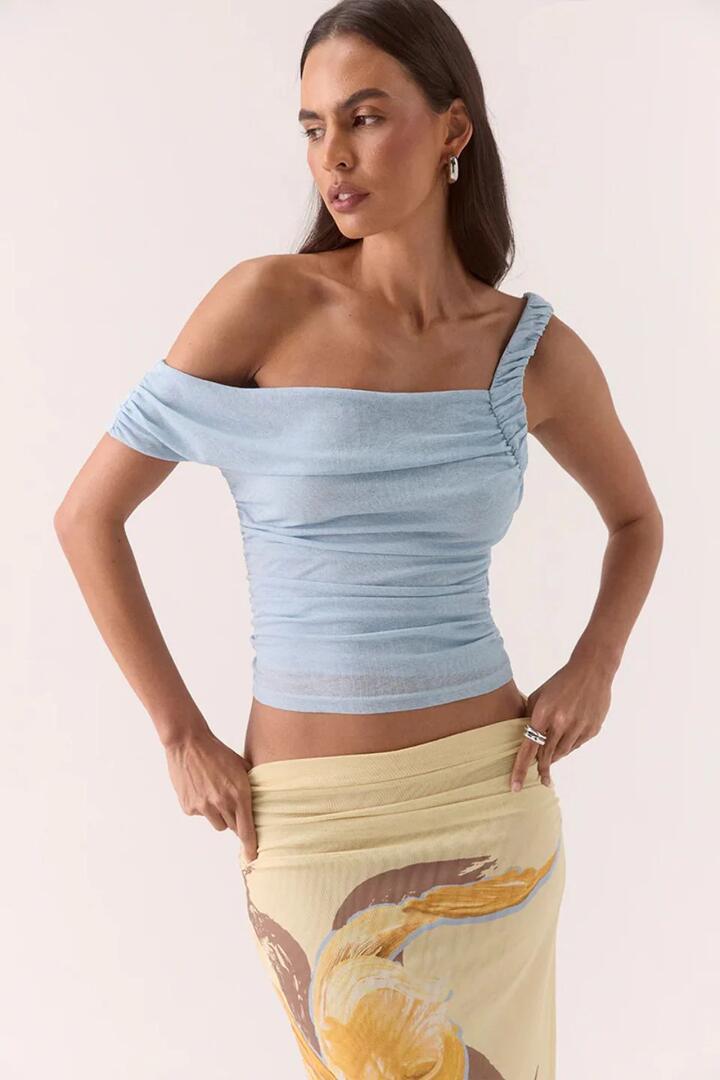 Image of a model wearing Tops. Product name - Rua Sky Asymmetric Off Shoulder Top in Blue colour by brand - Sovere