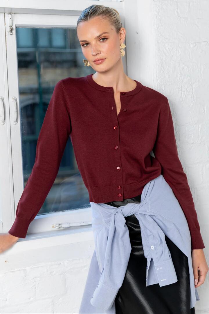 Image of a model wearing Outerwear. Product name - Sanctify Burgundy Crewneck Cardigan in Burgundy colour by brand - Stories be Told