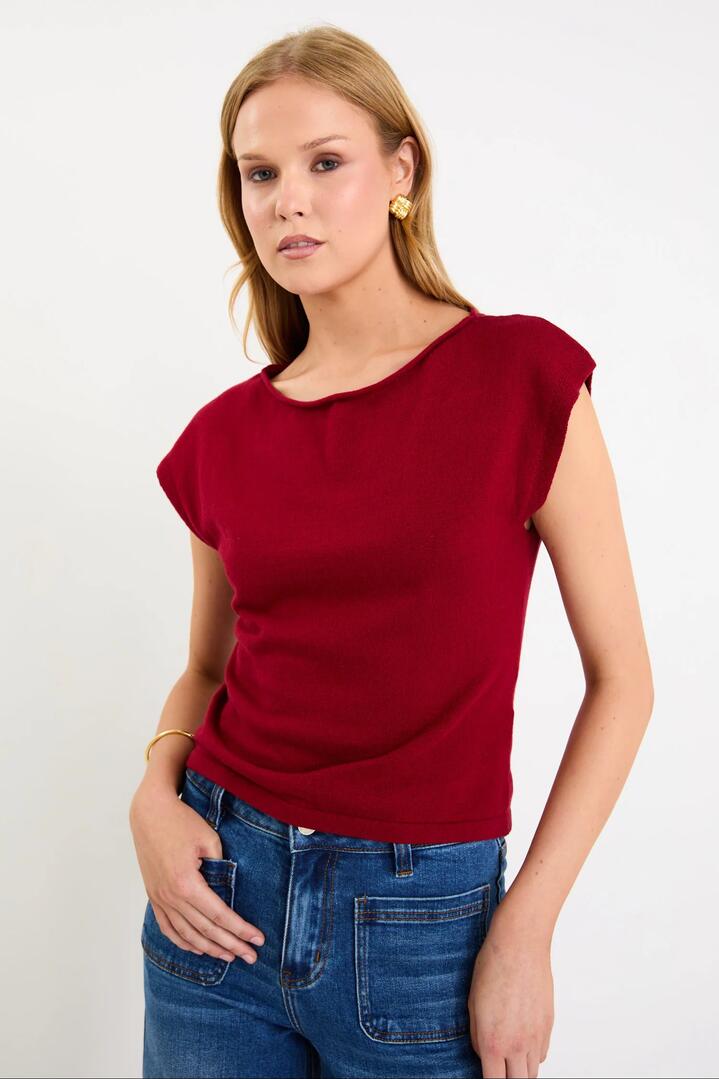 Image of a model wearing Outerwear. Product name - Innovate Cherry Red Cotton Cashmere Boatneck Sleeveless Knit Top in Cherry Red colour by brand - Ivy + Jack