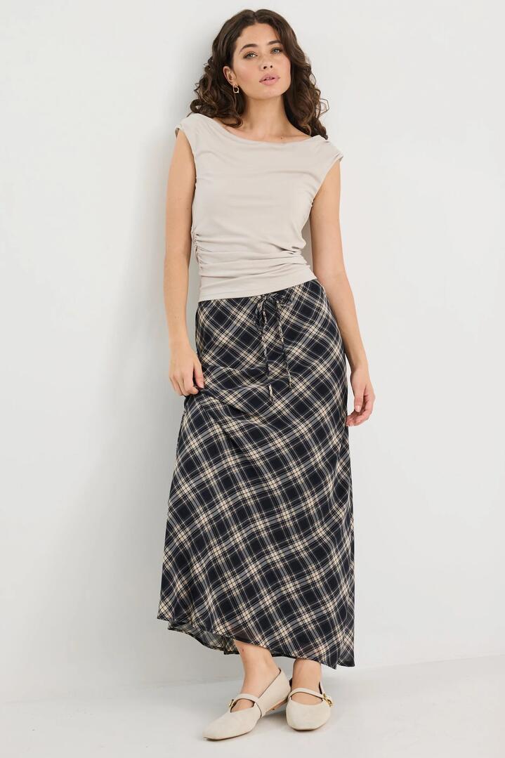 Image of a model wearing Skirts. Product name - Rally Black Check Chiffon Tie Waist Bias Maxi Skirt in Black Check Chiffon colour by brand - Among the Brave