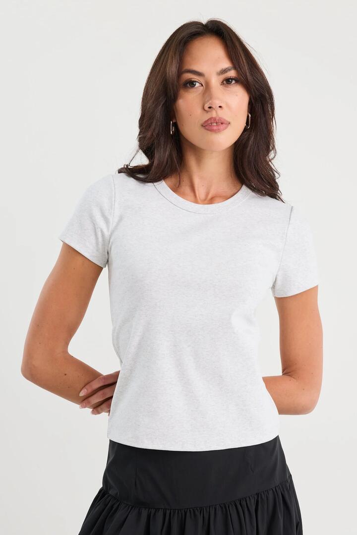Image of a model wearing Tops. Product name - Study Snow Marle Rib Longer Baby Tee in Snow Marle colour by brand - Stories be Told