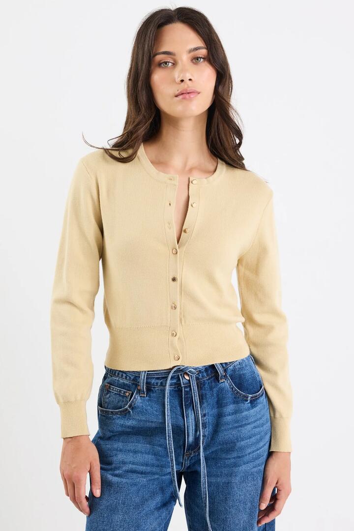 Image of a model wearing Outerwear. Product name - Fortune Honey Crewneck Cardigan in Honey colour by brand - Stories be Told
