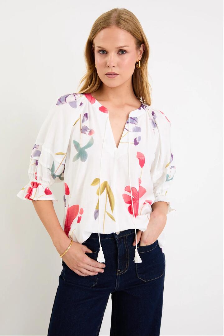 Image of a model wearing Tops. Product name - Cassia Cream Poppy Floral V Neck Short Pin Tuck Sleeve Mandarin Collar Top in Cream Poppy Floral colour by brand - By Rosa.