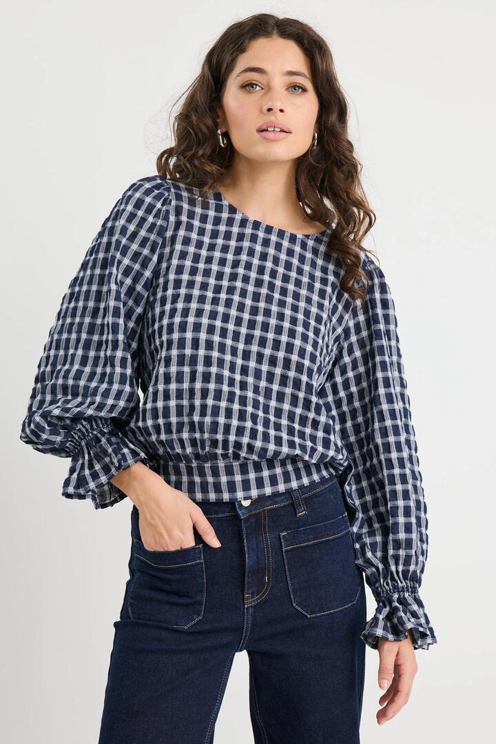 Image of a model wearing Tops. Product name - Imagine Ink Check Shirred Back Panel LS Top in Ink Check colour by brand - Ivy + Jack