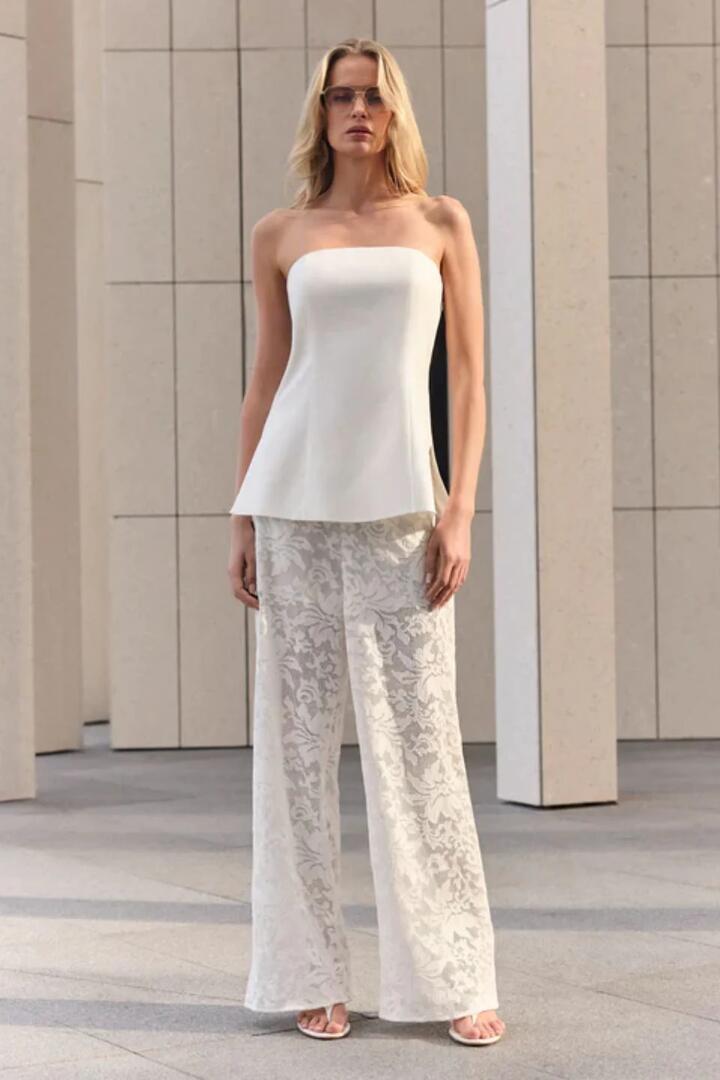 Image of a model wearing Tops. Product name - Marseille White Linen Bandeau Top in White colour by brand - Esmaee