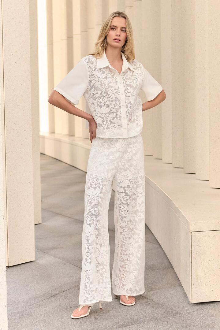 Image of a model wearing Pants. Product name - Parasol White Lace Pant in White colour by brand - Esmaee
