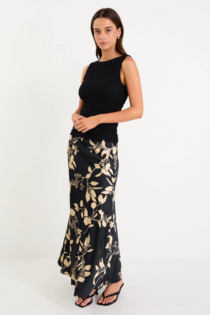 Image of a model wearing Skirts. Product name - Prodigy Black Beige Floral Satin Bias Cut Maxi Skirt in Black Beige Floral colour by brand - Stories be Told