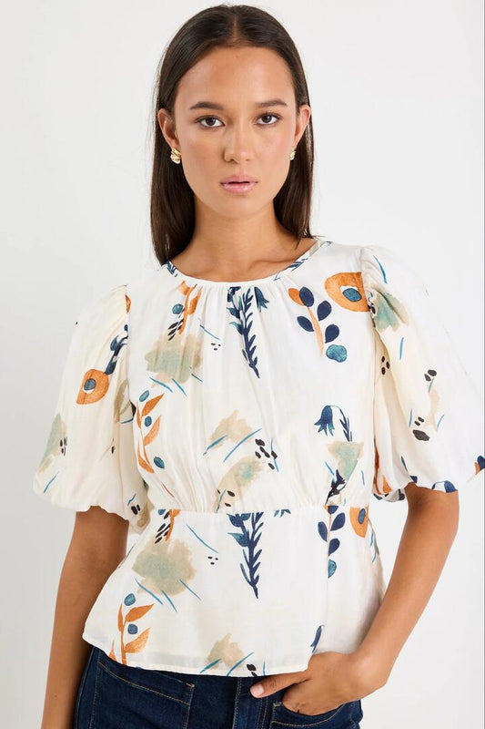 Image of a model wearing Tops. Product name - Finali Earthy Botanical Bubble Sleeve Top in Earthy Botanical colour by brand - Stories be Told