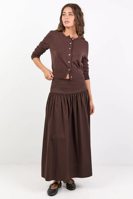 Image of a model wearing Skirts. Product name - Affinity Chocolate Cotton Blend Shirred Back Tiered Maxi Skirt in Chocolate colour by brand - Ivy + Jack