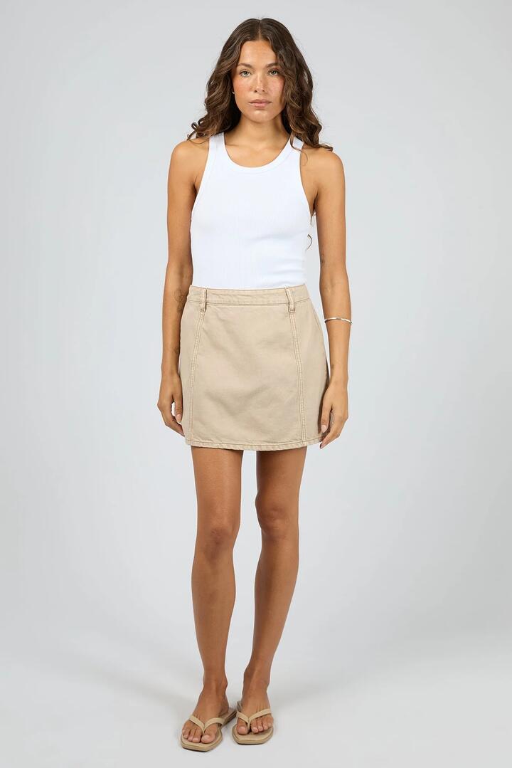 Image of a model wearing Skirts. Product name - Cove Beige Denim Mini Skort in Beige colour by brand - Silent Theory