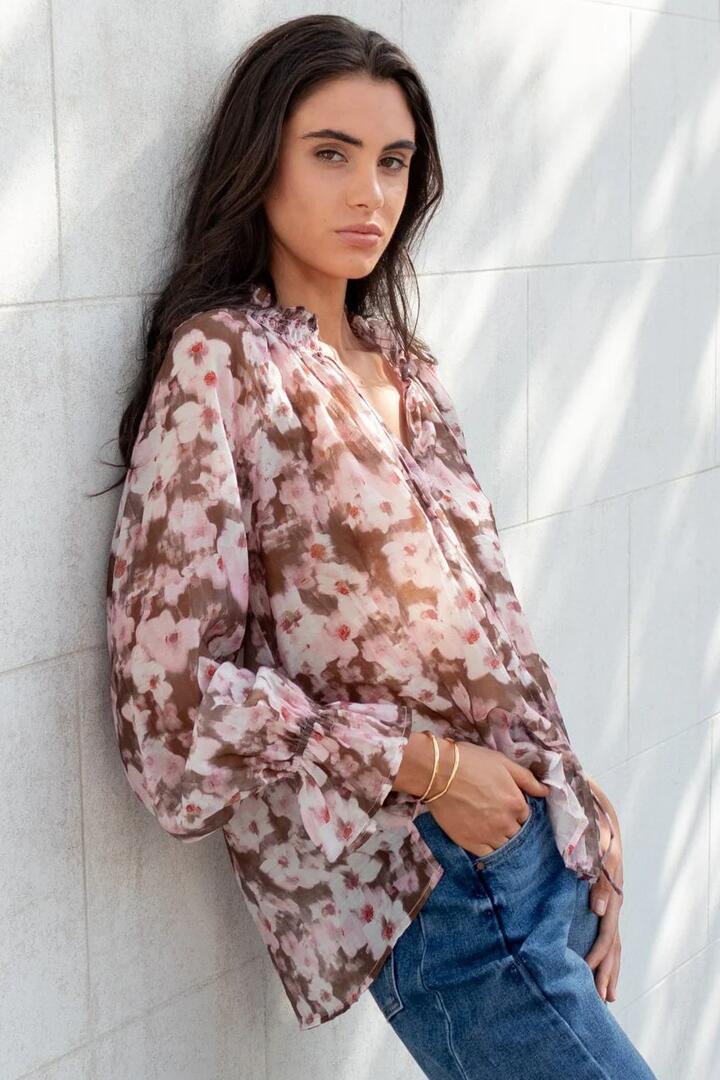 Image of a model wearing Tops. Product name - Odyssey Blush Chocolate Floral Shirred Neck LS Top in Blush Chocolate Floral colour by brand - Among the Brave