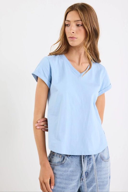 Image of a model wearing Tops. Product name - Rhyme Sky V Neck Short Sleeved Tee in Sky colour by brand - Among the Brave