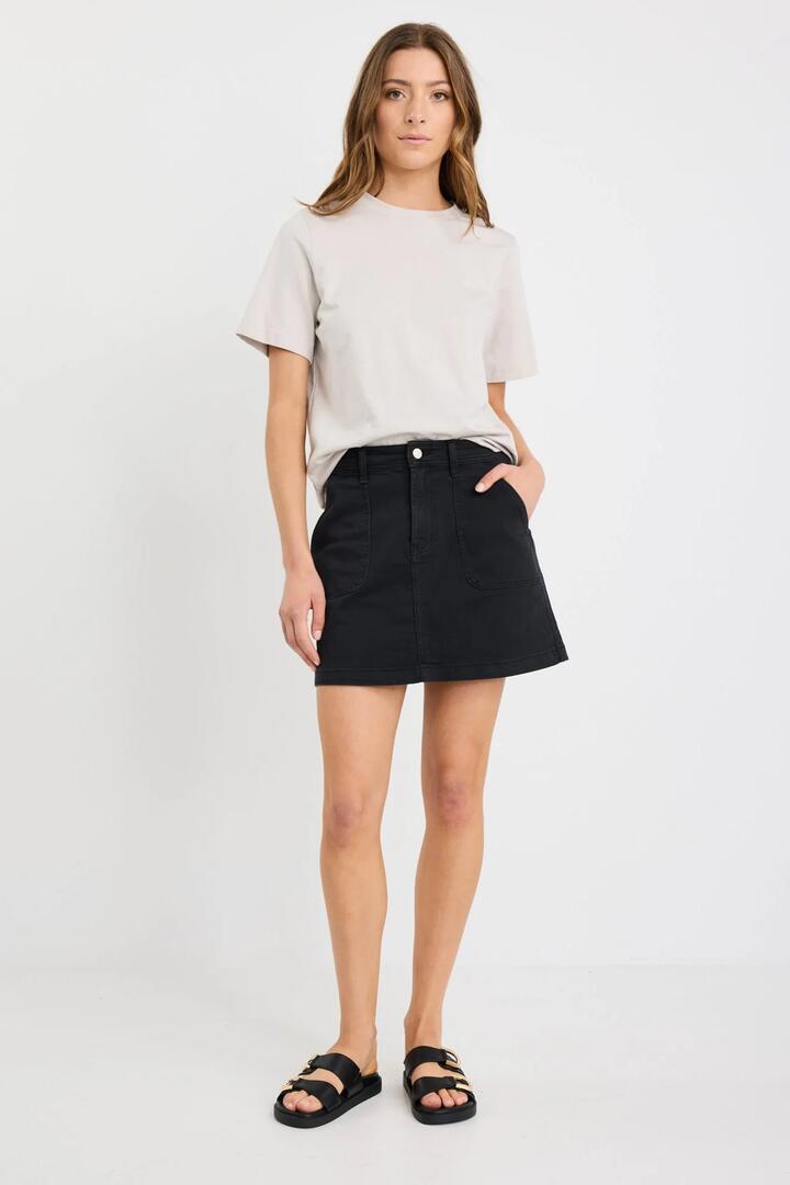 Image of a model wearing Skirts. Product name - Orchard Washed Black Pocket Front Denim Mini Skirt in Washed Black colour by brand - Ivy + Jack