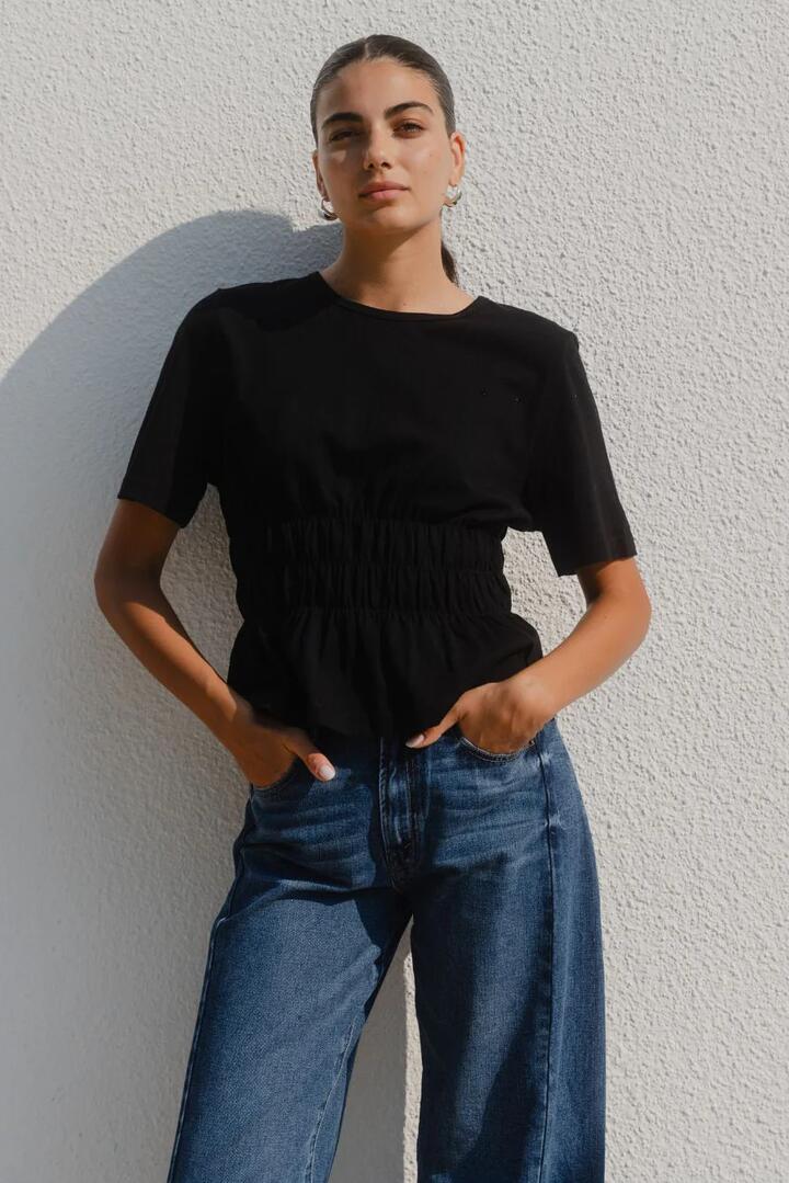 Image of a model wearing Tops. Product name - Svelte Black Shirred Detail SS Tee in Black colour by brand - Among the Brave