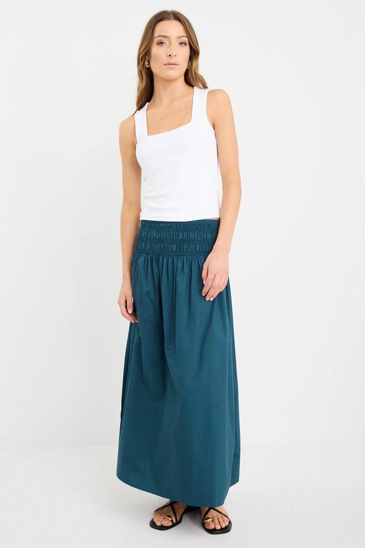 Image of a model wearing Skirts. Product name - Entourage Petrol Cotton Shirred Waist Maxi Skirt in Petrol colour by brand - Among the Brave