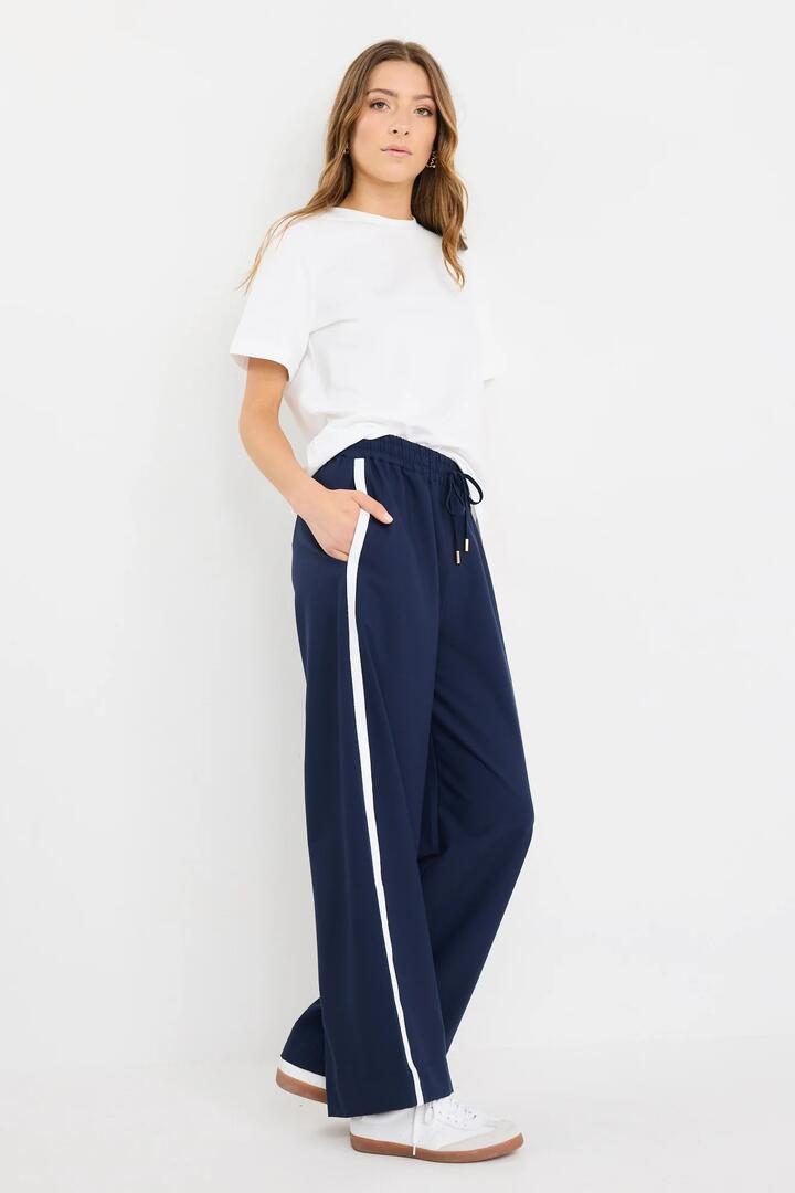 Image of a model wearing Pants. Product name - Townie Blue Side Stripe Elastic Waist Pants in Blue colour by brand - Stories be Told