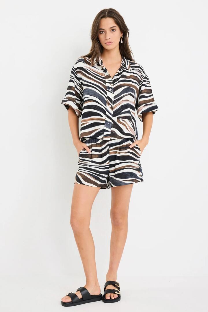 Image of a model wearing Shorts. Product name - Elaborate Chocolate Zebra Pull On Shorts in Chocolate Zebra colour by brand - Among the Brave