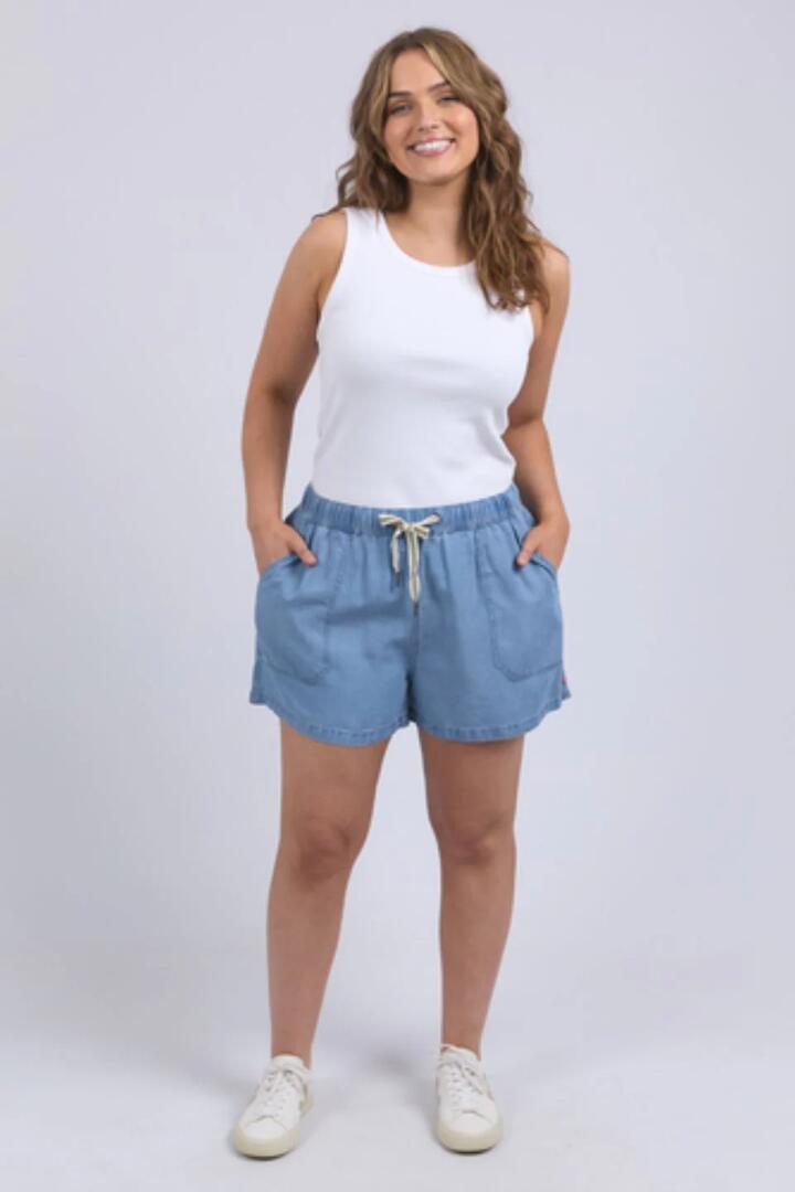 Image of a model wearing Shorts. Product name - Elliot Mid Blue Denim Chambray Tie Short in Blue colour by brand - Elm