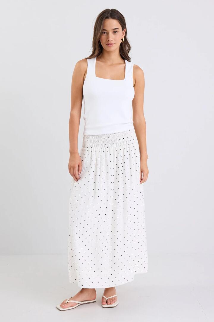 Image of a model wearing Skirts. Product name - Wanderlust Cream Polka Dot Shirred Waist Maxi Skirt in Cream Polka Dot colour by brand - Stories be Told