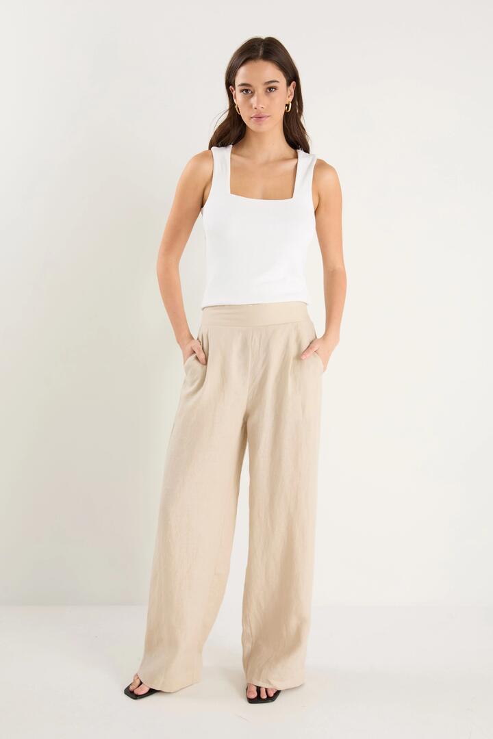 Image of a model wearing Pants. Product name - Guardian Stone Linen Pull On Wide Leg Pants in Stone Linen colour by brand - Among the Brave