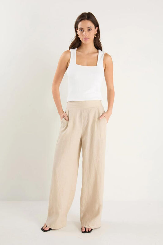 Image of a model wearing Pants. Product name - Guardian Stone Linen Pull On Wide Leg Pants in Stone Linen colour by brand - Among the Brave