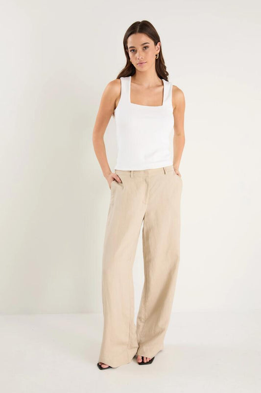 Image of a model wearing Pants. Product name - Shelter Oat Linen Viscose Flat Front Wide Pants in Oat colour by brand - RE:UNION Label
